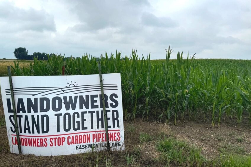 A sign urging landowners to stand together against eminent domain and carbon pipelines appears July 20 along Highway 11 in Lincoln County south of Sioux Falls. The issue has gained prominence in South Dakota as Summit Carbon Solutions seeks a permit for a network of carbon capture pipelines.