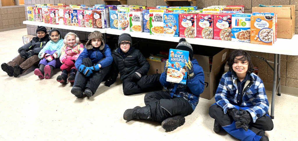 Courtesy Photos
Holy Trinity student council members with the donated cereal, which they arranged in a domino course (below) and invited the student body to observe to topping of the cereal boxes.