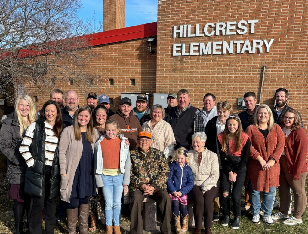 Harry and Connie Mansheim (seated) and their extended family gathered outside Hillcrest Elementary School on Thanksgiving for a nostalgic photo. Hillcrest is a mini-alma mater for the family, many of whom attended there and where a daughter is in her 20th year as a teacher. (Courtesy photo)