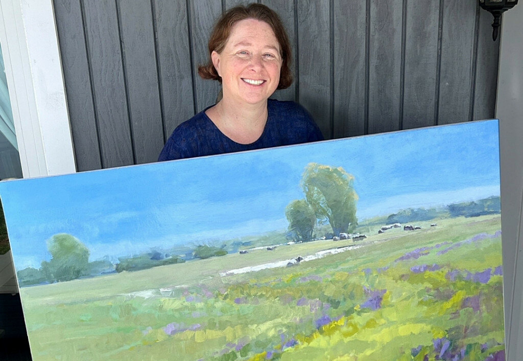 Visual artist Jessie Rasche of Brookings poses with her original painting titled “Spring Wild Flowers” in May. The piece was proposed for purchased to the South Dakota Arts Council for its annual Art For State Buildings program. The SDAC purchased the painting for inclusion in the state collection of nearly 120 original artworks in and near the State Capitol Building in state buildings in Pierre. (Photo courtesy South Dakota Arts Council)