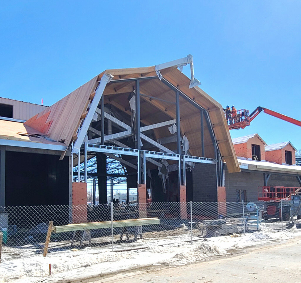 Photos by Curt Nettinga/Plainsman
Workers install tongue-and-groove siding to the edge of the barn-like front opening on the soon-to-be-completed Dakota Events CompleX on the South Dakota State Fairgrounds.