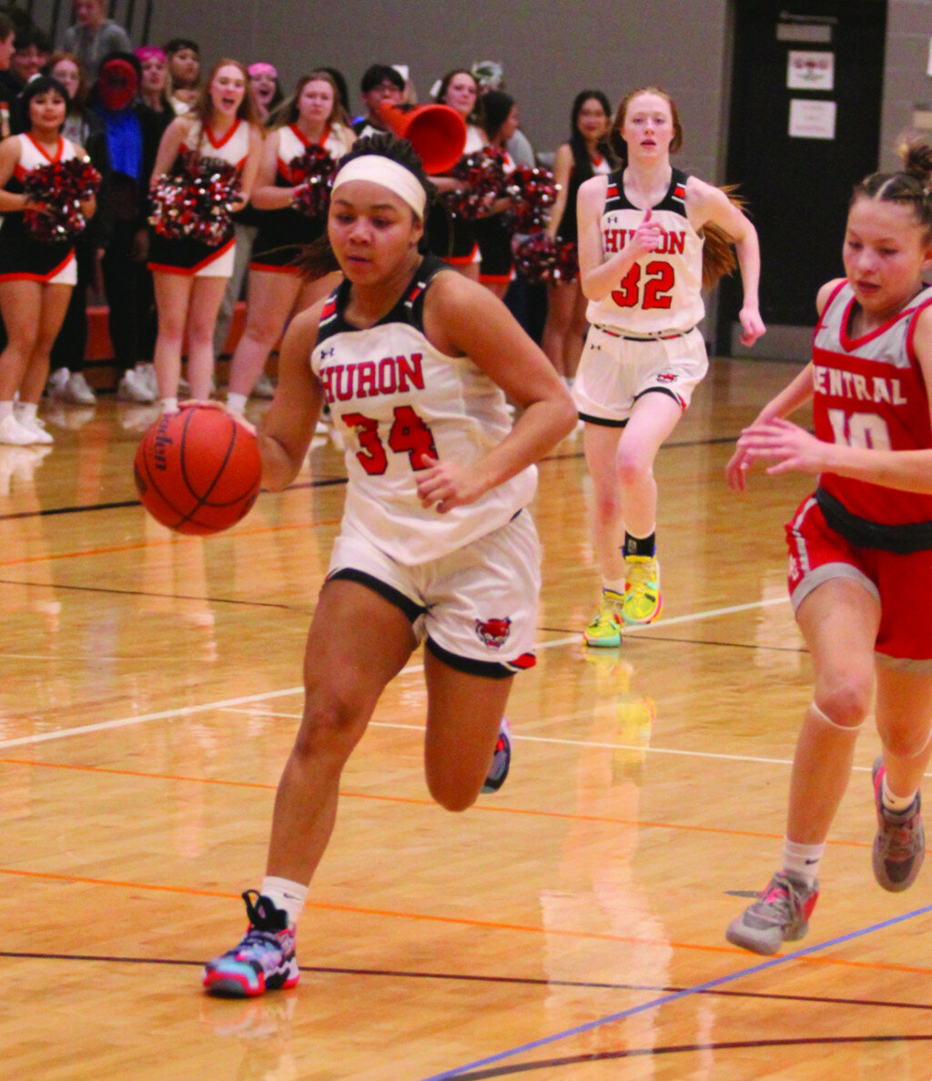 PHOTOS BY MIKE CARROLL/PLAINSMAN
Above: Huron’s Heavan Gainey heads for the basket after getting a steal as Tracelyn Strand of Rapid City Central trails on the play during their game Friday at the Huron Middle School gym. 
Below: Huron’s Hamtyn Heinz puts up a shot against Rapid City Central teammates Leah Landry (15) and Adriana Young during their game Friday at the Huron Middle School gym.