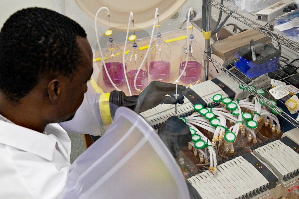 SDSU photo: The POET Bioproducts Institute will play an essential role in the scaling up technologies, such as a probiotic mixture for weanling piglets developed by associate professor Joy Scaria and his research team in the Department of Veterinary and Biomedical Sciences. Doctoral student Seidu Adams takes samples from minibioreactors that will help determine which gut bacteria are most effective at preventing diseases, such as diarrhea in piglets and even Clostridium difficile in humans.