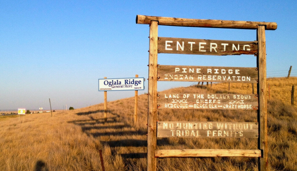 A sign hands outside the entrance to the Pine Ridge Indian Reservation in South Dakota, home to the Oglala Sioux tribe, on Sept. 9, 2012. (AP Photo/Kristi Eaton, File)
