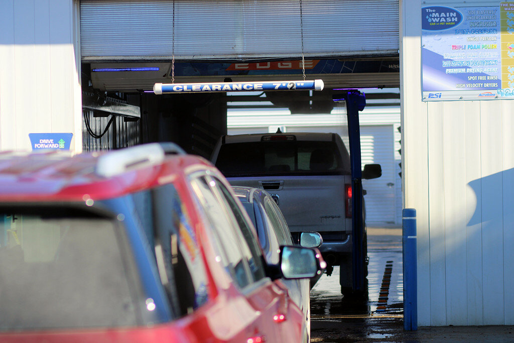 Cars wait their turn to clean the winter grime off at the car wash on South Main in Brookings on Wednesday afternoon. Temperatures touched 55 degrees and locals happily began decidedly spring-feeling errands. (Josh Linehan/Brookings Register)