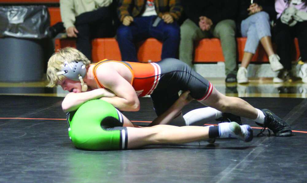 PHOTOS BY MIKE CARROLL/PLAINSMAN
Huron’s Carter Nelson works to put Gable Uhrig of Pierre on his back during their 106-pound match Friday at Huron Arena.