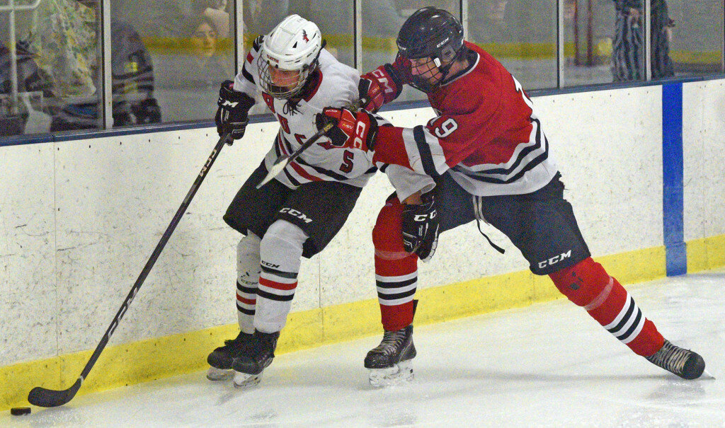 James D. Cimburek/P&D
Huron’s Jack Pedersen, right, tries to push Yankton’s Kylen O’Connor into the boards during their boys’ hockey match on Tuesday at the Kiwanis 4-H Ice Center in Yankton.