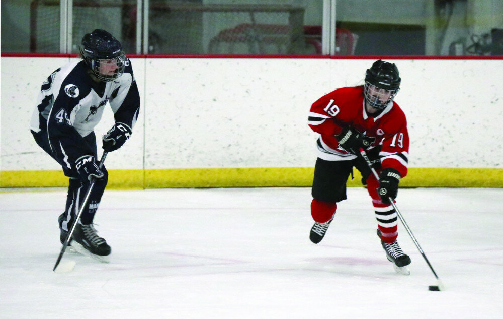 PHOTOS COURTESY OF JOEL BERGESON
Huron’s Taylor Sorben handles the puck against Mitchell’s Alannah Lang during their girls’ U14 game on Friday in Mitchell.