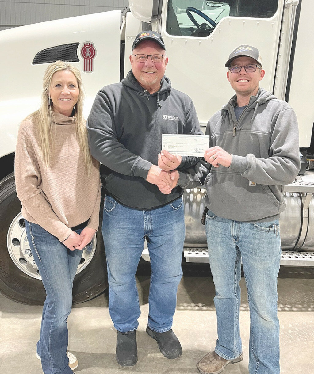 Pictured above are members of Liberty’s Troops Leanne  and Cody Amdahl being presented a check for $2500 by Mike Blum, center, for their organization.