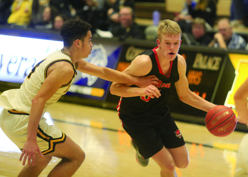 JACOB NIELSON/MITCHELL REPUBLIC
Huron’s Anderson Porisch dribbles against defensive pressure by Mitchell’s Markus Talley during their game Tuesday at the Corn Palace in Mitchell.