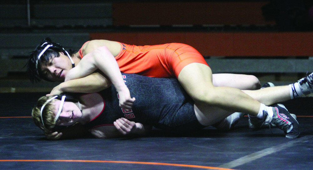PHOTOS BY MIKE CARROLL/PLAINSMAN
Huron’s Shar Ler Moo Ser wrestles Zach Hegemann of Brookings in a 175-pound match on Tuesday at Huron Arena.
