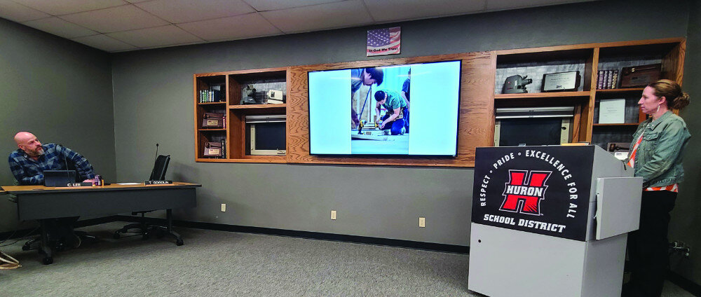 Curt Nettinga / Plainsman
Jolene Konechne shares pictures of one of the CTE classes at Monday’s School Board meeting.