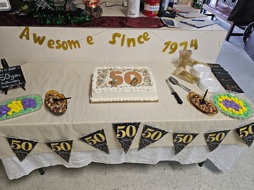 Pie Tin catering delivered a glittery golden anniversary cake to the Services for Seniors Activity Center during their Awesome Since 1974 party.