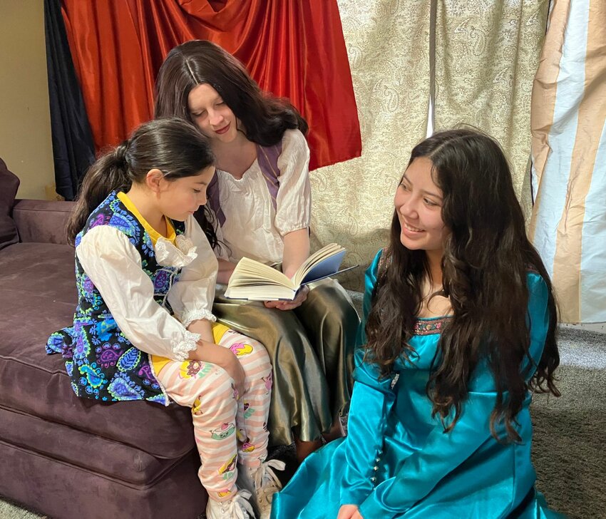 Scheherazade reads with the prince and her sister, Dinarzad played by Gigi Fuentes (l-r), Rory Winter and Lillian Fuentes. Public performances of “The Arabian Nights” are scheduled for next week.