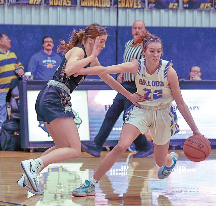 Senior Lily Nichols (No. 22) drives past her Buffalo opponent earlier in the season.