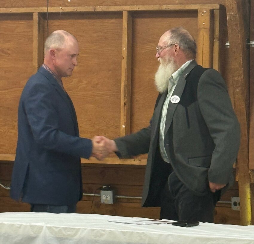 Jd Williams (left) and Allen Slagle (right) shake hands at the debate.