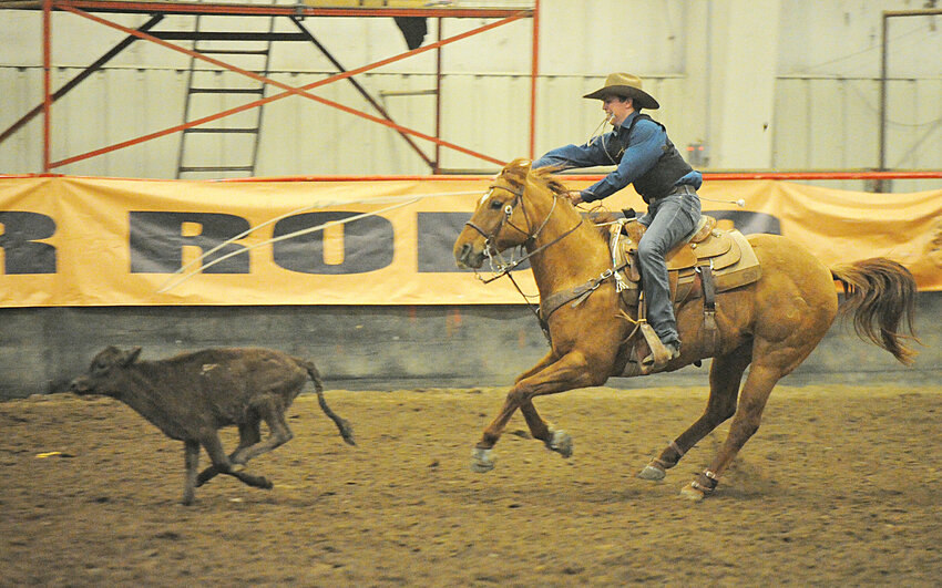 Goshen County’s own Kyler Clark, a freshman at EWC, chases down a calf in tie-down roping during the short go round on Sunday.