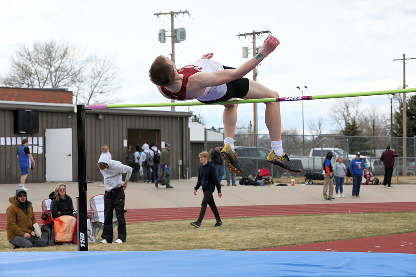 Sophomore Nathan Miller clears the pole in the high jump at Wheatland. Miller snagged second place in the event, posting a mark of 6 feet, 4 inches.
