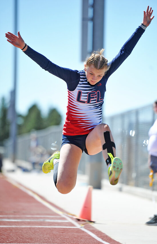 Freshman Addi Wilkins comes in for a landing in the triple jump at Burns. Wilkins placed seventh in the event.