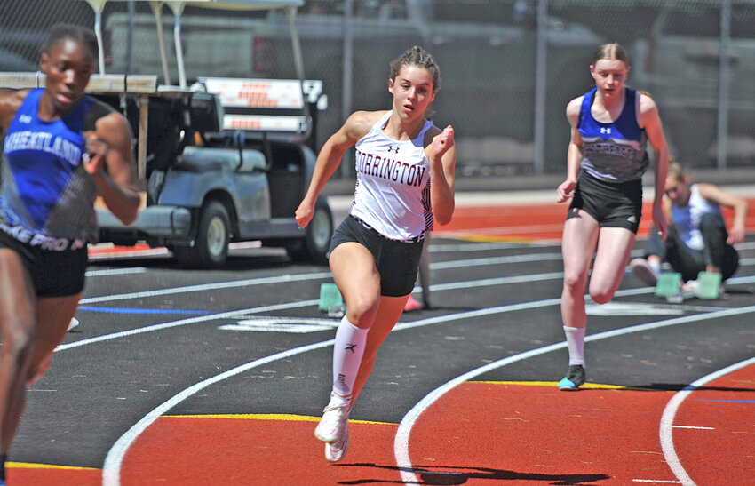Sophomore Brooklyn Asmus explodes from the starting blocks in the 200-meter dash at Burns. Asmus broke the Torrington High School records in two events as well as garnering gold.