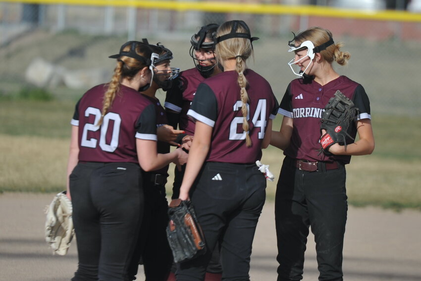 THS fielders huddle before an inning against Cheyenne South.