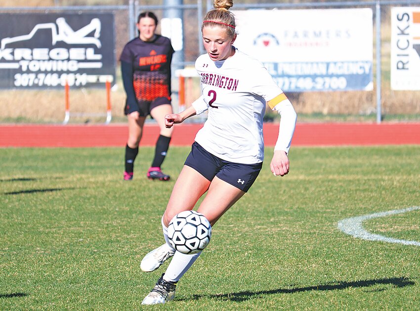 Junior Maggie Jacobson maneuvers the ball down the field against Newcastle on April 19.