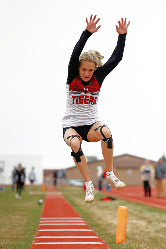 Senior Melody ZumBrunnen comes in for a landing in the long jump at Pine Bluffs. ZumBrunnen garnered gold in the event and also picked up first place in the 100-, 200- and 400-meters.