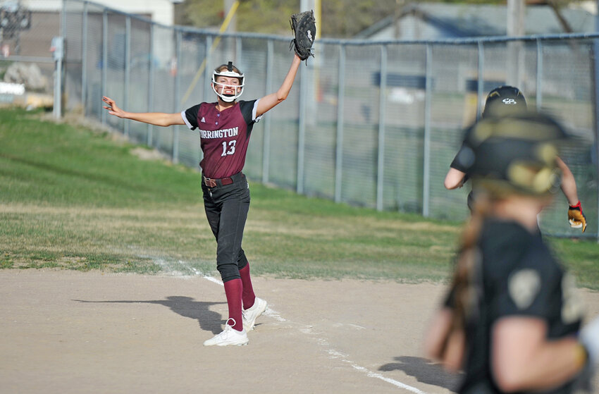 Freshman Aftyn Hager closes her glove around the ball while defending first base against Cheyenne South on April 22.
