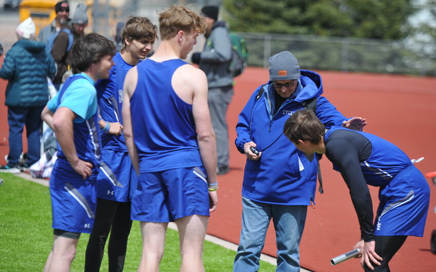 Coach Bullington congratulates the 4x400-meter relay team after senior Wyatt Gladson, junior Kannon Tippetts, sophomore T.J. Moats and junior William Knowlton snagged gold in the event.