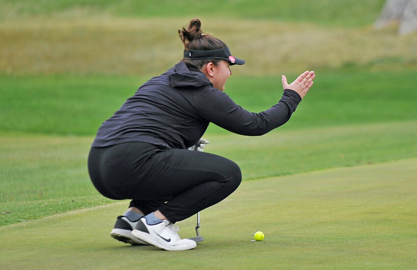 Junior Kaleigh Waymire calculates her shot on the green at Cottonwood Country Club in Torrington during the home golf tournament on Friday. Waymire led the Lady Blazers with a sixth-place finish.