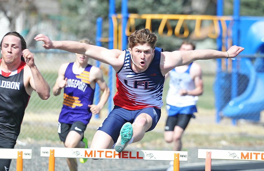Junior Louden Bremer files over the hurdles at the Mitchell Invitational on April 4. Bremer won the 110-meter hurdles at the Cheyenne Invite on April 29.