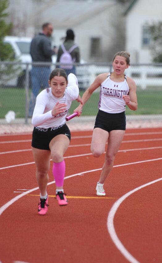 Junior Jaycee Hurley shifts into high gear as sophomore Natalie Hawes approaches with the baton in the 4x100-meter relay. The team went on to snag gold in the event.