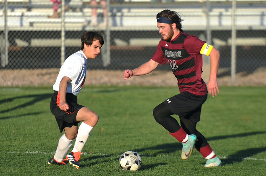 Junior Kaiden Riggs maneuvers the ball through his opponent’s territory during the May 2 home game against Newcastle. Riggs played solid defense and scored a goal for Torrington.