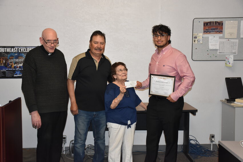 Marcos Bailey Martinez smiles as he accepts the scholarship certificate and check from Margaret Puebla, chairman of the scholarship committee. Pictured from left to right, Pastor Father Ray of Saint Rose of Lima Catholic Church, D.J. Martinez, Our Lady of Guadalupe Society President, Puebla and Martinez.