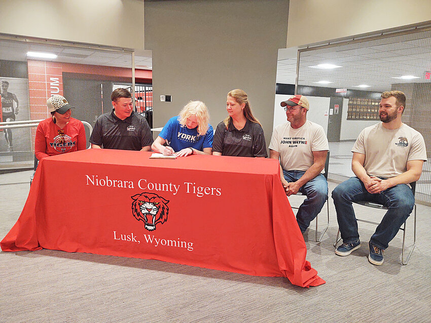 NCHS graduate Aidan Mattheus signs his letter of intent to continue his basketball career at York University in Nebraska on Friday. Pictured, from left, are assistant coach Andie Hubbard, head coach Ed Fullmer, Aidan Mattheus, parents Susan Bartel and Tim Bartel and brother Alex Mattheus.