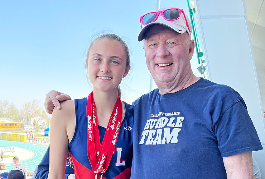 Coach Rick Cotant with Lingle-Fort Laramie High School hurdler Grace Gibson in 2023.