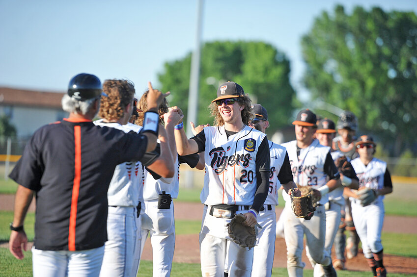 Ayden Desmond, No. 20, leads the Tigers in celebration of their July 10 victory against Wheatland. The Tigers secured the No. 2 seed for the district playoffs following a July 16 win against Cheyenne.