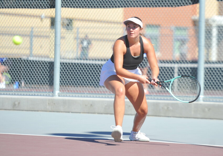 Senior Madix McIntosh returns a serve during a match against Gillette in August. McIntosh battled tough opponents from Casper with determination on Saturday.