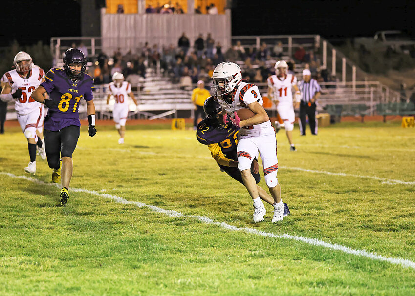 Junior Nathan Miller drives the ball forward against Saratoga during the September 20 away game. Also pictured is senior Jackson Smith, No. 11 and sophomore Raynce Brott, left.