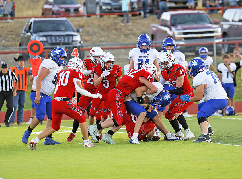 Senior Quintin Bieri, No. 42, leads the Tigers D-line in stopping the Cyclones’ advance during the home game on September 27. Also pictured, from left, are senior Ridge Kupke (No. 10), junior Nathan Miller (No. 3) and sophomore Raynce Brott (No. 52).