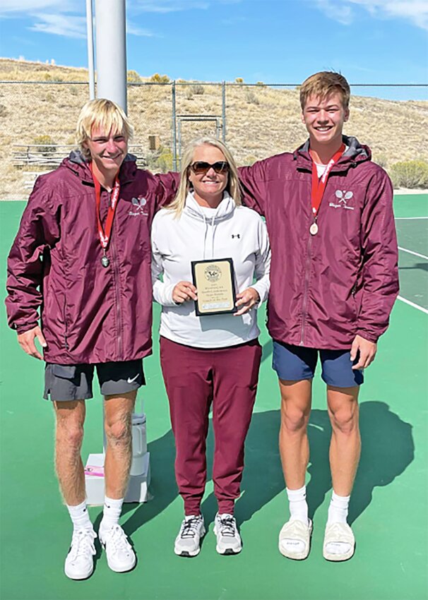 Torrington High School head tennis coach Lauren Shields, center, received the South Conference boys’ tennis coach of the year award in September. Also pictured are senior singles players Elijah Hatch, left, and Skyler Thomas, right.