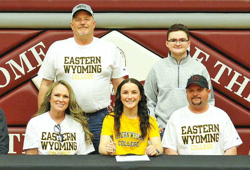 Torrington High School senior Olive Osmera, in front, center, signed to continue her volleyball and basketball careers at EWC in a ceremony in the Willi Gym on March 20. Also pictured, in back, is stepfather Kirk Rutt and brother Owen Osmera. In front, from left, is mother Shelly Rutt, Olive Osmera and father Kelly Osmera.