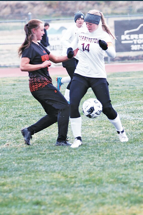 Sophomore Kynzi Thomas battles her Newcastle opponent for the ball during the April 17 away game. Thomas scored one of the penalty kicks during the overtime shootout that helped the Lady Blazers defeat Newcastle.