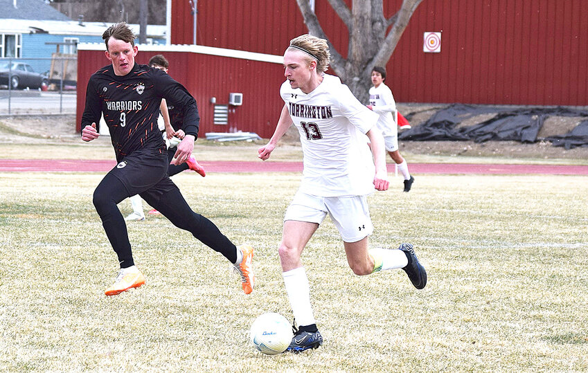 Senior Elijah Hatch, right, maneuvers the ball down the field during the April 4 game against Worland. Hatch scored the lone goal for Torrington during the April 22 away game versus Scottsbluff.