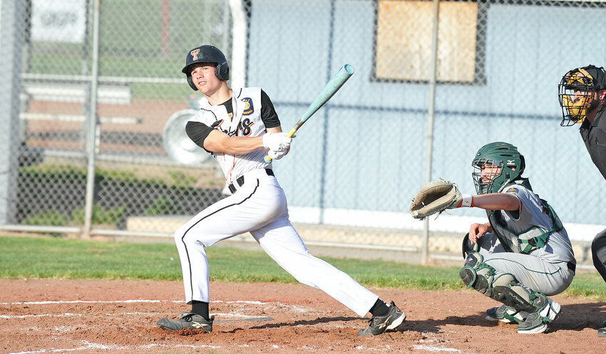 Home run! Colby Sandusky, left, hits a big fly into left field for the Tigers ‘A’ Legion team during the first game of the May 13 home double-header against the WESTCO Zephyrs from Scottsbluff.