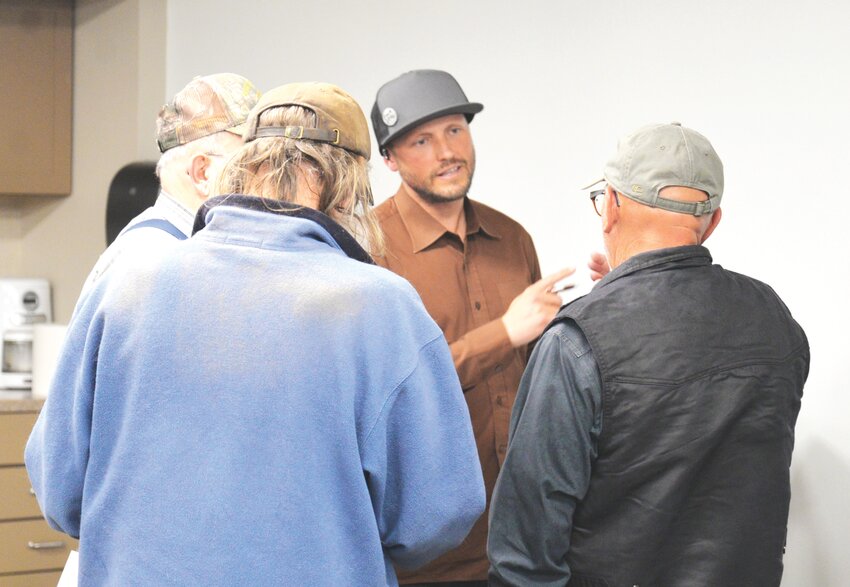 Dr. Alexander Dunlap (center) visits with locals at the Platte County Public Library last week to hear their opinions and concerns surrounding a proposed rare earth mine currently in the process of being developed west of Wheatland. The comments will be combined with those of other communities to give a clearer picture to researchers from the National Renewable Energy Laboratory of the impact such mines have on U.S. communities. The study will serve as a guide to better account for the risks and impacts of domestic mining, processing, manufacturing, recycling, and disposal of critical materials and energy technologies.