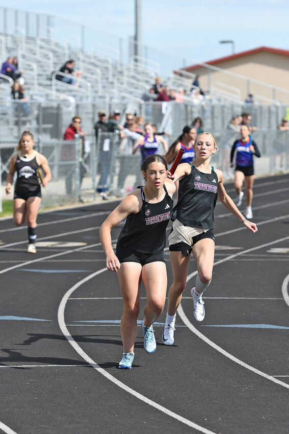 Junior Brooklyn Asmus, front, takes the baton from junior Trishell Pontarolo in the 1600-meter sprint medley relay at the 3A East regional track meet. Asmus, Pontarolo and teammates freshman Illyana Ponce and junior Natalie Hawes went on to capture gold in the event at 4:21.86.