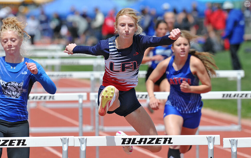 Senior Jada Kaufman clears a hurdle in the 100-meter prelims on Friday. Kaufman went on to garner silver in the finals on Saturday in addition to collecting three gold medals in the 300-hurdles and two relays.