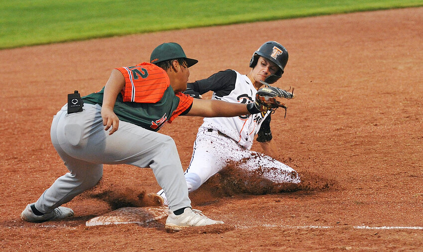 Owen Curry slides into third base moments before his WESTCO opponent from Scottbsluff catches the ball during the home-opener double header for the Torrington Tigers ‘C’ Legion team on Wednesday, May 14.
