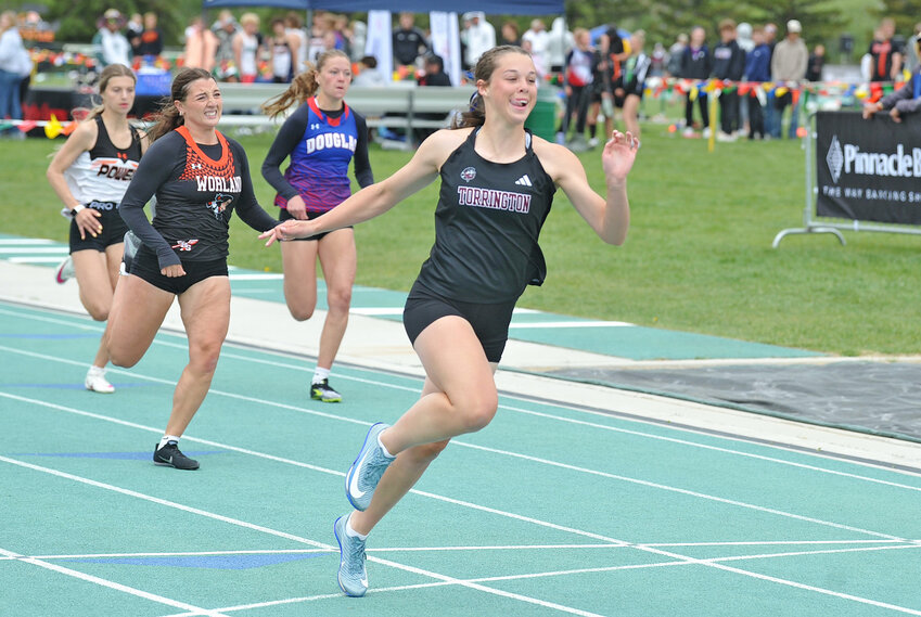 Junior Brooklyn Asmus crosses the finish line ahead of the competition in the finals for the 100-meters at the 3A state track meet in Casper on Saturday, May 24. Asmus clinched gold in both the 100- and 200-meters. The junior also clinched the Best of the Best Award in both events for posting the fastest time out of all classifications competing at state.